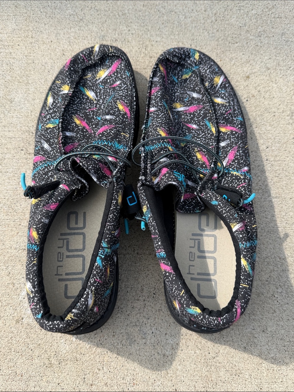 Hey Dude Men’s Black Casual Slip-On Shoes with Pink, Blue, & Yellow Accents